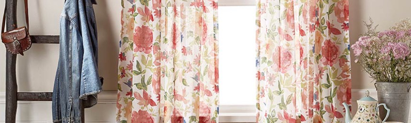 A set of floral curtains in a window. Starts the window treatment ideas blog post on paylessdailyonline.com.